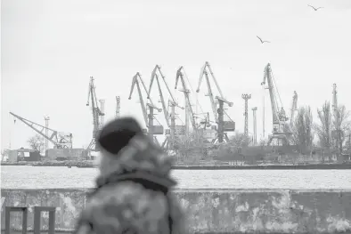  ?? ALEKSEY FILIPPOV/GETTY-AFP ?? A serviceman walks Feb. 11 in the border base in front of Ukraine’s Black Sea port of Mariupol.