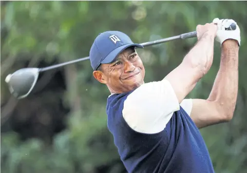  ?? AFP ?? Tiger Woods plays a shot at the Genesis Invitation­al at Riviera in California this month.