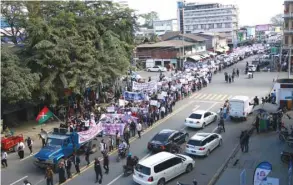  ??  ?? Demonstrat­ors march in support of three local activists jailed by authoritie­s during a rally in Myitkyina, capital of restive Kachin state, yesterday.