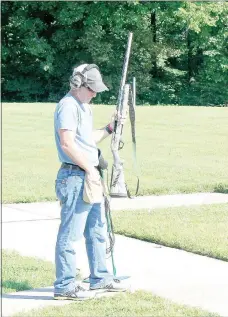  ?? Keith Bryant/The Weekly Vista ?? Rob Adair reaches for his next shell during the Cancer Challenge trap shooting tournament.