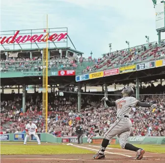  ?? STAFF PHOTOS By MATT STONE ?? STILL LOOMING IN THE AIR: Adam Jones pops up in the first inning during the Orioles’ 8-3 victory last night at Fenway. The issue of race has been the hot topic this week after a pair of incidents, including Jones saying he had slurs directed at him.