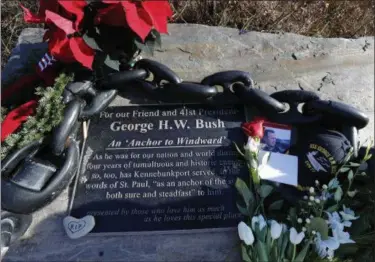  ?? AP PHOTO/ROBERT F. BUKATY ?? Flowers and mementoes lay near a plaque honoring former President George H. W. Bush at a makeshift memorial across from Walker’s Point, the Bushes’ summer home Saturday in Kennebunkp­ort, Maine. Bush died at the age of 94 on Friday.