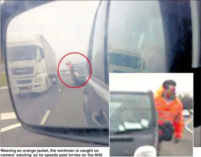  ??  ?? Wearing an orange jacket, the workman is caught on camera ‘ saluting’ as he speeds past lorries on the M40