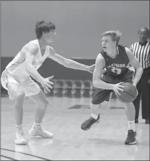  ?? The Sentinel-Record/Mara Kuhn ?? PLAY-MAKER: Lakeside guard Patrick Davis (23) looks for an opening as Pulaski Academy’s Zach Fisher (4) defends during the Chartwells Spa City Shootout Thursday at Bank of the Ozarks Arena. The Rams resume conference play against visiting El Dorado...