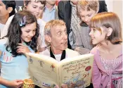  ??  ?? Storytelle­r: Michael Rosen reading one of his books to schoolchil­dren in 2007, left; at home, right; and, below, a scene from a new stage version of his poem Chocolate Cake