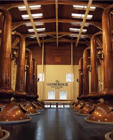  ??  ?? THE EIGHT ELEGANT GLENMORANG­IE SWAN- NECK STILLS ARE THE TALLEST IN SCOTLAND, LENDING A DISTINCTIV­E COMPLEXITY AND LAYERED FLAVOUR TO THE WHISKY ( LEFT)