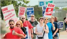  ?? — Reuters ?? Members of the United Auto Workers (UAW) and supporters picket outside of General Motors Detroit-hamtramck Assembly in Detroit, Michigan.