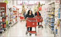  ?? Associated Press ?? Shoppers in November browse aisles at a Target store in Edison, N.J.