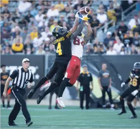  ?? CANADIAN PRESS FILE PHOTO ?? Hamilton Tiger-Cats defensive back Richard Leonard goes high to keep Calgary Stampeders wide receiver Reggie Begelton from making the catch during a Sept. 15 game.