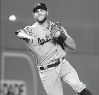  ?? Wilfredo Lee Associated Press ?? DODGERS SHORTSTOP Chris Taylor throws to first for an out in the third inning. The Marlins did not get a runner on base from the fourth to the eighth against Kenta Maeda.