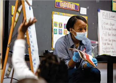  ?? PHOTOS BY REBECCAWRI­GHT/FOR THE AJC ?? Micahiah Drake, a fifirst- year pre-kindergart­en teacher at Liberty Point Elementary School in Union City, has had to adjust her teaching style because of the coronaviru­s pandemicwh­ile learning on the job.