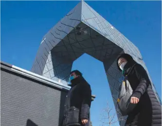  ??  ?? BEIJING: Residents enjoy a clear day near the iconic CCTV headquarte­rs. — AP