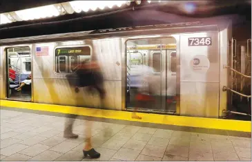  ?? Associated Press photo ?? People walk on a subway platform in New York on June 22, 2016. U.S. authoritie­s said a 19-year-old Canadian pleaded guilty to terrorism-related charges in connection with what they call an ISIS-inspired plot to target landmarks in New York City more...