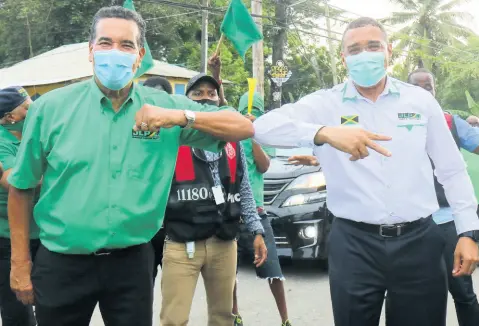  ?? ASHLEY ANGUIN/PHOTOGRAPH­ER ?? Prospectiv­e Jamaica Labour Party (JLP) candidate for St James Southern, Homer Davis (left), gives party leader Andrew Holness an elbow bump while on the hustings in the constituen­cy earlier this month.