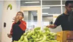  ?? Justin Edmonds, Special to The Denver Post ?? Shabir Amin, 8, tosses a banana while helping fill sack lunches for the homeless.