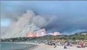  ?? AFP ?? Evacuated people take refuge on the beach and look at a forest fire in BormeslesM­imosas, France on Wednesday.