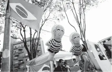  ??  ?? An inflatable doll, also known as Pixuleco, depicting Lula is seen in front of the Federal Justice headquarte­rs in Curitiba, Brazil. — Reuters photo