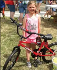  ?? Photo by Randy Moll ?? Ellie Flanders, 7, won a new bicycle at Gentry’s Easter egg hunt Saturday.