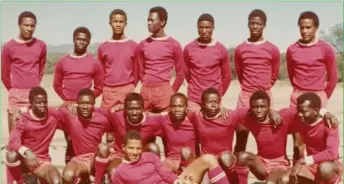  ?? ?? Oval ball chaser...Hoffman (stretching on the turf - with ball), attired in the blood and foam strip of St. Joseph’s Secondary School (Dobra) Rugby X1. Standing from left: Adolf Philander, Wilfred Inotiira Emvula, Lewa Awaseb (d+), Vekuii Rukoro (d+), Barry Mulunga, Bernard Goagab, Job Tjiho. Kneeling from left: Franz ‘Bro Zonk’ Gaseb, Edward Kaoti, Michael Mbudje, Kaspar Agapitus, Kuiri Tjipangand­jara, Johannes ‘Mazo’ Taurob, Kanutus Elago. Front: Gebhardt Hoffman Tjihero.