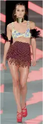  ?? — AFP — AFP ?? A model walks the runway during Miami Fashion Week in Florida on Sunday.