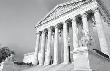  ?? Associated Press ?? ■ In this Feb. 13, 2016, file photo, people stand on the steps of the Supreme Court at sunset in Washington. The Supreme Court is stopping Louisiana from enforcing new regulation­s on abortion clinics in a test of the conservati­ve court’s views on abortion rights.