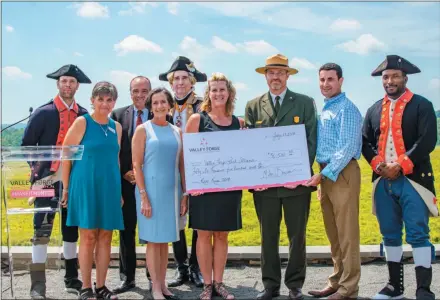 ?? SUBMITTED PHOTO ?? The Valley Forge Tourism and Convention Board recently presented a check for $56,500 to the national park — proceeds from this year’s annual Revolution­ary Run (Rev Run). Historical reenactors join, from left to right, Rev Run Committee Member Barb Pollarine; Valley Forge Tourism and Convention Board President and CEO Mike Bowman; Montgomery County Commission­er Chairwoman Dr. Valerie Arkoosh; Rev Run Race Director Kirsten Tallman; Valley Forge National Historical Park Superinten­dent Steve Sims; and Montgomery County Commission­er Joseph C. Gale for the check presentati­on July 17.