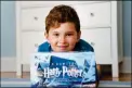  ?? ASSOCIATED PRESS ?? THEO GALKIN, 8, POSES for a picture with his set of Harry Potter books at his home in South Orange, N.J.