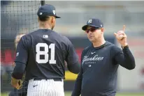  ?? CHARLIE NEIBERGALL/AP ?? New York Yankees manager Aaron Boone talks with Gil during a Feb. 15 spring training workout in Tampa, Fla.