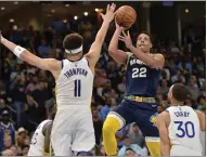  ?? ?? Grizzlies guard Desmond Bane (22) shoots against Warriors guards Klay Thompson (11) and Stephen Curry (30) during Game 2 of a second-round playoff series on Tuesday.