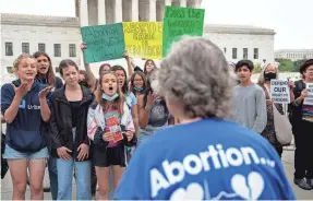  ?? ANNA MONEYMAKER/GETTY IMAGES ?? Abortion-rights advocates confront anti-abortion advocates in front of the U.S. Supreme Court building on Wednesday.