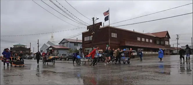  ?? Photo by Nils Hahn ?? LABOR DAY IN NOME— Five bathtub racing teams raced down Front Street during the Great Bathtub Race, a Nome tradition on Labor Day.