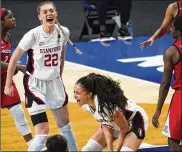  ??  ?? Stanford guard Haley Jones (center) and forward Cameron Brink (22) celebrate in front of Arizona guard Bendu Yeaney (23) during the women’s Final Four NCAA college basketball tournament Sunday in San Antonio.