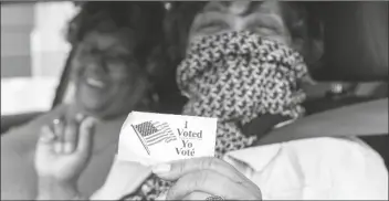  ?? ASSOCIATED PRESS ?? PATRIA, 57 (right) who asked to use only her first name, and Janet Wilson, 68, both of Washington, smile after receiving their “I Voted” stickers after submitting their ballots from the curbside voting line on Tuesday, at Malcolm X Opportunit­y Center. “This is the most important election in history, sure to determine the direction of the country and even the world for any foreseeabl­e future,” says guest columnist Michael Miller.