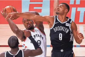  ?? KEVIN C. COX/AP ?? The Raptors’ Serge Ibaka, center, grabs a rebound against the Nets’ Timothé Luwawu-Cabarrot, right, and Caris LeVert, left, during the third quarter of Game 1 on Monday.