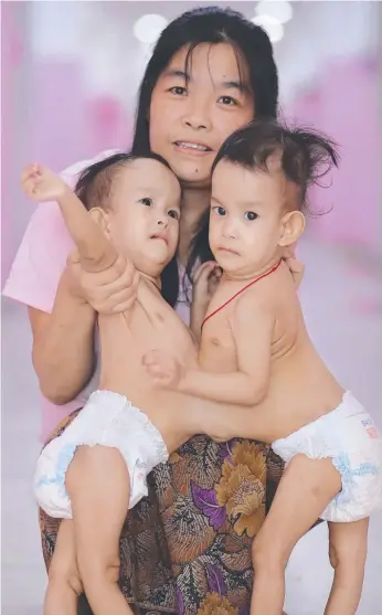  ?? Picture: ALEX COPPEL/HERALD SUN ?? Mum Bhumchu with conjoined twins Nima and Dawa Pelden, 14 months, who will be surgically separated at the Royal Children’s Hospital in Melbourne.