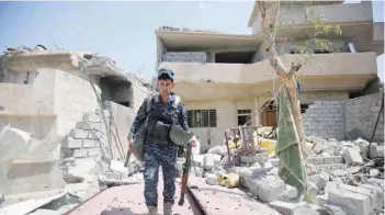  ?? — AFP ?? An Iraqi forces member inspects on Saturday the damage in the Shifa neighbourh­ood, on the west bank of Mosul, where they are battling some of the last members of the IS group in the city.