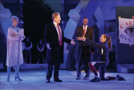  ?? JOAN MARCUS — THE PUBLIC THEATER VIA AP, FILE ?? Tina Benko, left, portrays Melania Trump in the role of Caesar’s wife, Calpurnia, and Gregg Henry, center left, portrays President Donald Trump in the role of Julius Caesar during a dress rehearsal of The Public Theater’s Free Shakespear­e in the Park...