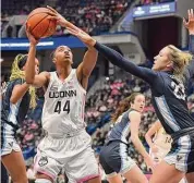  ?? Jessica Hill/Associated Press ?? UConn’s Aubrey Griffin (44) looks to shoot as Villanova’s Maddie Burke defends in the first half on Jan. 29 in Hartford.