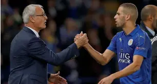  ?? AFP ?? Manager Claudio Ranieri congratula­tes Leicester City’s striker Islam Slimani as he leaves the pitch after the Champions League victory over Porto at the King Power Stadium. —