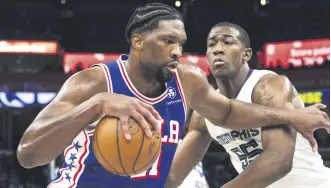  ?? ?? Philadelph­ia 76ers guard Joel Embiid (L) drives while defended by Memphis Grizzlies center Trey Jemison during an NBA game, Memphis, Tennessee, U.S., April 6, 2024.