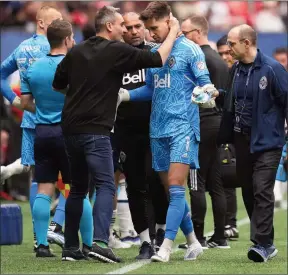  ?? The Canadian Press ?? Vancouver Whitecaps head coach Vanni Sartini, left, embraces goalkeeper Thomas Hasal as he leaves the field with an injury during the second half of an MLS soccer game against Toronto FC in Vancouver on May 8,