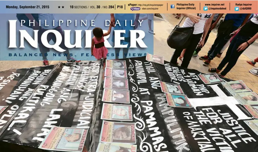  ?? JILSON SECKLER TIU ?? VICTIMS OF MARTIAL LAW A child looks at a big mock coffin painted with slogans and bearing pictures of people who disappeare­d during the military rule of President Ferdinand Marcos. The human rights group Karapatan and Bagong Alyansang Makabayan in Southern Tagalog displayed the coffin on the grounds of Baclaran Church in Parañaque City on Sunday, the eve of the 43rd anniversar­y of the declaratio­n of martial law.