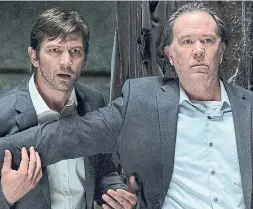  ?? STEVE DIETL TRIBUNE NEWS SERVICE/NETFLIX ?? Michiel Huisman, left, and Timothy Hutton in The Haunting of Hill House. The Netflix series makes use of the ‘slow burn’ TV form.