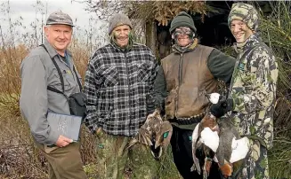  ??  ?? Fish & Game Ranger Hamish Angus with duck hunters Craig Drain, Brett Dawson and Harrison Drain near Lumsden on Saturday.