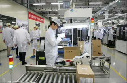  ?? KIN CHEUNG — THE ASSOCIATED PRESS FILE ?? A staff member works on a mobile phone production line during a media tour in Huawei factory in Dongguan, China’s Guangdong province. Huawei Technologi­es Co. is one of the world’s biggest supplier of telecommun­ications equipment. The United States is delaying tariffs on Chinese-made cellphones, laptop computers and other items and removing other Chinese imports from its target list altogether in a move that triggered a rally on Wall Street.