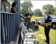  ?? Arkansas Democrat-Gazette/STATON BREIDENTHA­L ?? North Little Rock police officers Nick Stewart (center) and Alex Santucci talk with Joyce Martin on Saturday at her home in the Dixie Addition neighborho­od as they go door to door to give residents evacuation informatio­n.