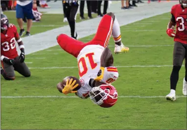  ?? (AP/Doug Murray) ?? Kansas City Chiefs wide receiver Tyreek Hill does a back flip into the end zone for a touchdown during the Chiefs’ victory over the Tampa Bay Buccaneers on Sunday in Tampa, Fla. Hill finished with 13 catches for 269 yards and 3 touchdowns, including 7 catches for 203 yards and 2 scores just in the first quarter. More photos available at arkansason­line.com/1130kctamp­a.