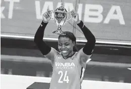  ?? JOHN LOCHER AP ?? Arike Ogunbowale of the Dallas Wings holds up the MVP trophy after scoring 26 points to lead the WNBA All-Stars past the U.S. Olympic team.