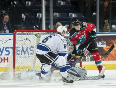  ?? MARISSA BAECKER/Shootthebr­eeze.ca ?? Kelowna Rockets forward Leif Mattson, right, attempts to screen Victoria Royals goaltender Griffen Outhouse as Jameson Murray of the Royals defends during first-period WHL action on Friday night at Prospera Place. The Rockets won 2-0.