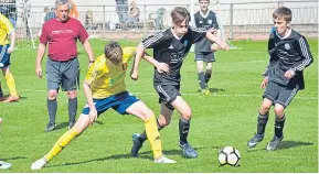  ??  ?? Match action from Ferry Athletic U/16’s (yellow) John Clark Motors Cup Final win over Broughty United at North End Park. Ferry (right) won 2-1.